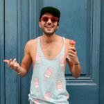 Person in Teal Ice Cream Print Tank Top Holds Ice Cream